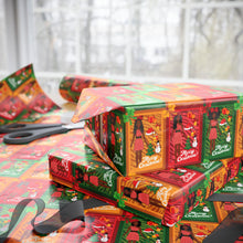 Load image into Gallery viewer, Stack of Christmas-themed boxes with decorative designs on a table.