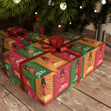 Load image into Gallery viewer, Festive African American Doll - Christmas Gift Wrap Paper (Braids Hairstyle)under a decorated Christmas tree.